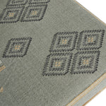 Bobbin Ottoman in Ocean, detail of turned bobbin legs